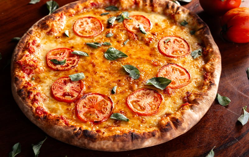 Margherita punch pizza with San Marzano tomatoes and fresh basil